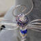 Handmade wire dragonfly ornament with bead details and a subtle celestial charm